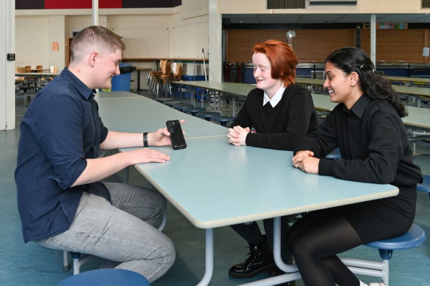 Joe Elvines shares his results with Harriet Lyons and Anna Leo at Nairn Academy.