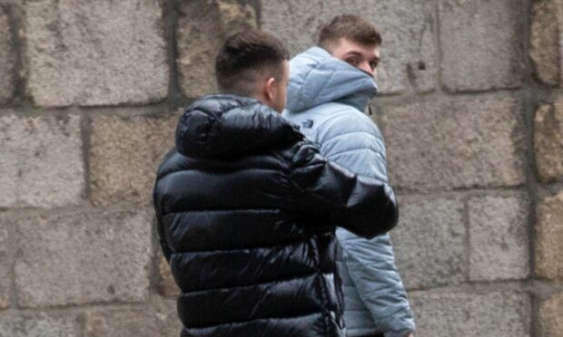 Ben Mitchell, left, and Cameron Rae tried to hide their faces as they left court.