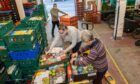 Cfine foodbank volunteers packing up food parcels at the charity's Poynernook Road base in Aberdeen. The organisation is in line for a £430,000 funding grant to help the city's hungry. Picture by Kath Flannery/DCT Media.