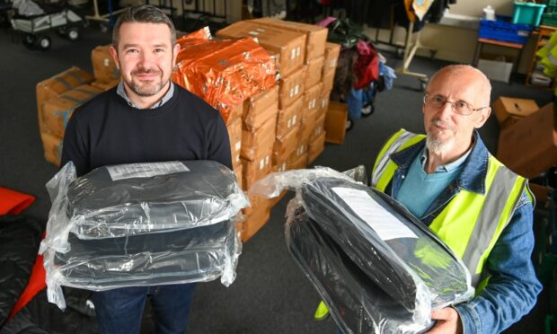 Stuart McCaskill from BP (left) has donated sleeping bags to Aberdeen Street Friends - accepted by chairman Albert Annand. Picture by Kami Thomson / DC Thomson.
