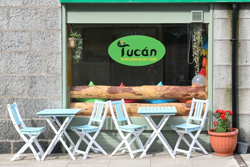 The outside of tucan aberdeen with outdoor tables and chairs
