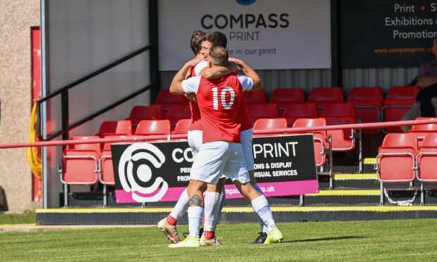 Culter's Nikolas Wozniac celebrates with No 10 Liam Brady Todd. Image:   
Kami Thomson/ DC Thomson.