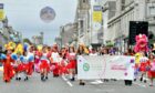 Hundreds of volunteers, groups and charity mascots marched down Union Street as Celebrate Aberdeen returned. Picture by Kami Thomson.