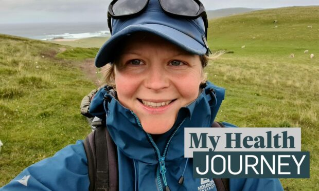 Lynn Munro outside on a windy morning with the 'My Health Journey' logo next to her