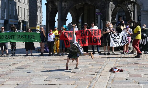 Protesters at the Castlegate on Monday, August 1 2022. Pictured dancing is Gillian Ruth Siddons. Photo: Paul Glendell.