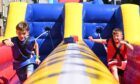 Dylan Bremner and Hunter Campbell enjoying one of the bungee inflatables. Picture by Paul Glendell/DC Thomson.