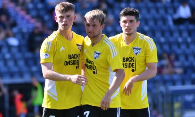 Max Gillies, left, celebrates his first Peterhead goal with Ewan Murray and Jack Brown. Photo by Duncan Brown
