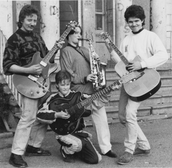 1992 - Fred Perry, 24, Lee Downey, 15, Derek McDonald, 26, and Michael Cooper, 11, practice playing their instruments in front of the community centre in Powis, Aberdeen