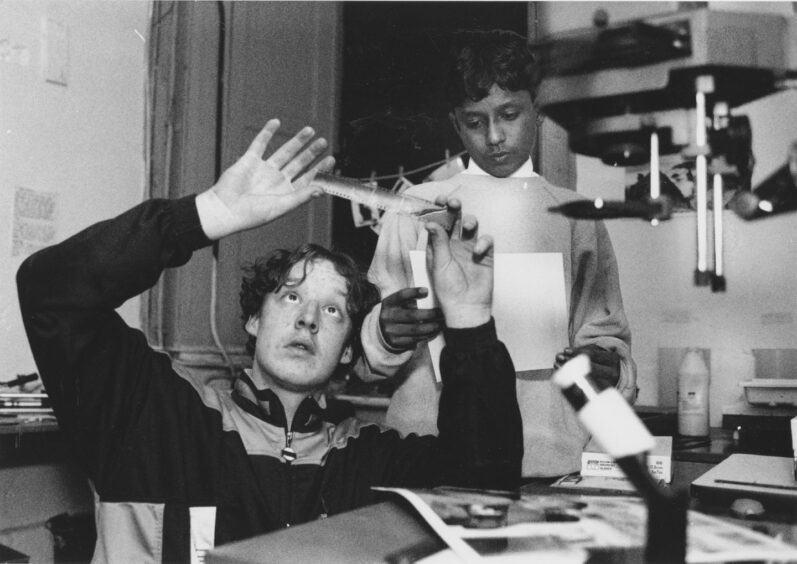 15 April 1993 'That's the one: Jason Wilson (17) and Kamah Hussain, of the Powis Young People's Project, get down to some printing in the darkroom for the Fotofeis photography festival. Members of an Aberdeen youth poject recently hit by a break-in are saying ''cheese'' after winning a £500 gant in a national photography festival. The windfall follows a break-in at the Powis Young People's Project, Powis Circle, Aberdeen, two weeks ago. The group is continuing with its contribution to the North East's Fotofeis festival. They intend to show Aberdonians what it's like to be a ''Young Powiser'' by producing pictures which depict their home area. Group members will use photography and words to make people aware of the hive of activity and community spirit in the area