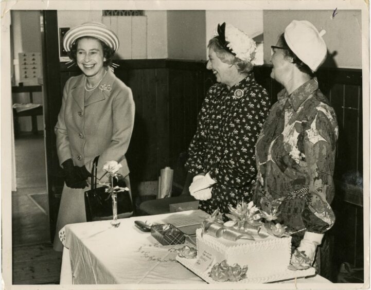 The Queen laughing with stall-holders