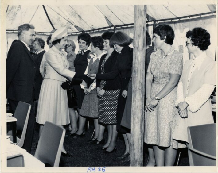 Queen Elizabeth II shaking hands with stall-holders 