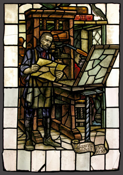 A photo of a stained glass window depicting Edward Raban, Aberdeen's first printer