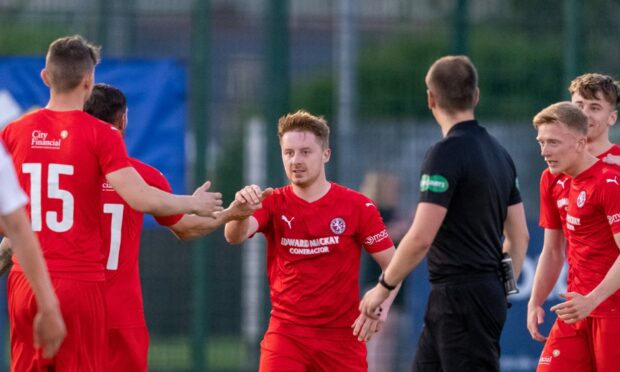 Andrew Macrae, centre, has extended his contract with Brora Rangers