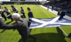 Ross County, led by secretary Donnie MacBean, carry the First Division title flag on to the park in 2012.