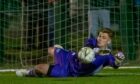 Buckie Thistle goalkeeper Lee Herbert saves a penalty from Brora Rangers Jordan MacRae