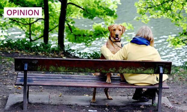 Lindsay Bruce with her dog Barley at the spot where she first became curious about the stories behind Aberdeen's many memorial benches (Photo: Kami Thomson/DC Thomson)