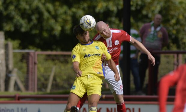 Buckie Thistle's Sam Urquhart, left, wins a header up against Euan Spark of Brechin City