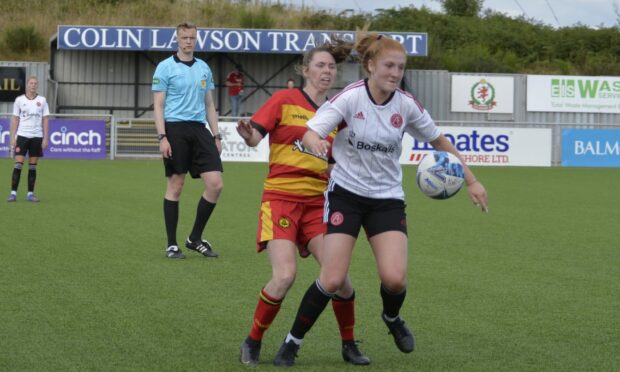 Aberdeen's Eilidh Shore battles with Partick Thistle's Rachel Donaldson in the 2-2 draw. Image: Wullie Marr.