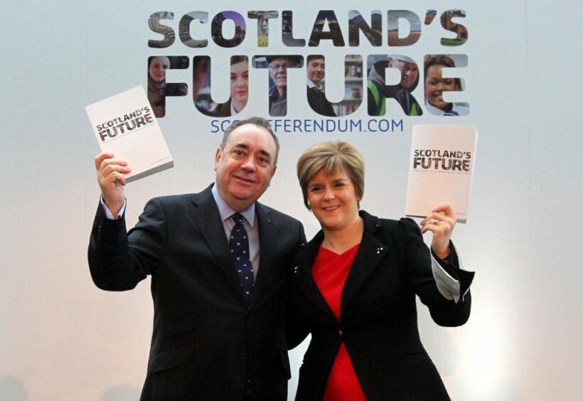 Pictures shows Alex Salmond and Nicola Sturgeon side by side holding the white paper for the independence referendum campaign. 