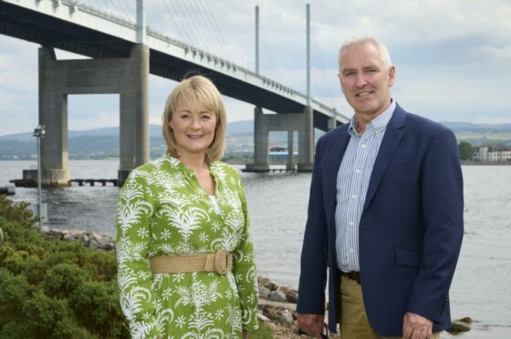 Yvonne Crook and Councillor Karl Rosie in front of bridge.