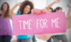 A woman holding a sign that says time for me