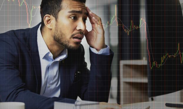 Stressed businessman on the stock market, trading during a financial crisis. Online trader in a bear market, looking at stocks crashing. Market crash, stock default and economy failure or depression; Shutterstock ID 2167686391; purchase_order: ; job: