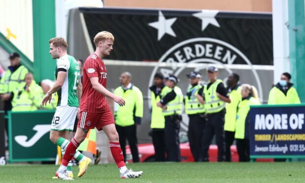 Aberdeen defender Liam Scales is sent off after receiving a second yellow card against Hibs.