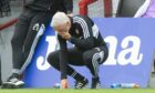 Aberdeen manager Jim Goodwin looks dejected at full time after conceding an injury time goal.