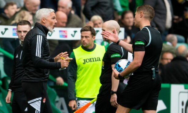 Aberdeen boss Jim Goodwin protests to referee David Dickinson at Easter Road.