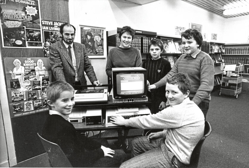 An Aboyne schools pupils crowded around a computer