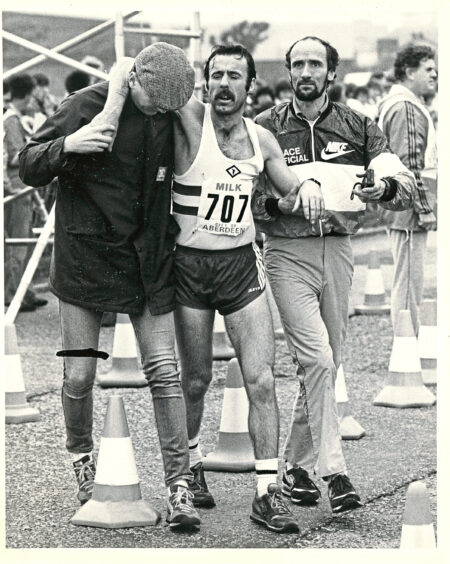 1984 - James Farquhar is helped to the first aid tent by race officials.