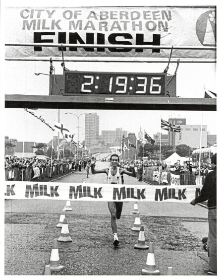 1984 - Marathon winner Mark Burnhope raises his arms in celebration as he crosses the finish line.