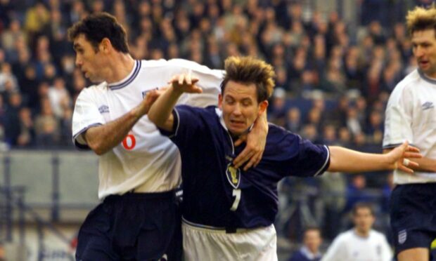Billy Dodds in action against England defender Martin Keown.