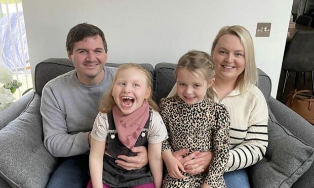 Lauren Clark (right) with husband Ross and daughters Lola and Maddie at home in Elgin. She's spoken about a need for more cerebral palsy support. Image: Lauren Clark