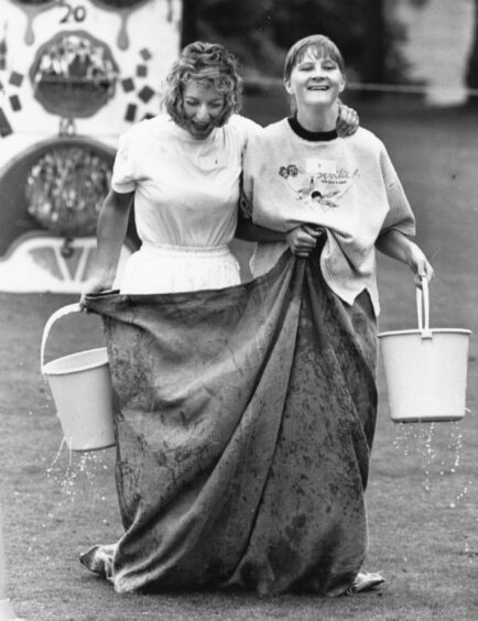 Two women in a sack race in September at It's a Knockout