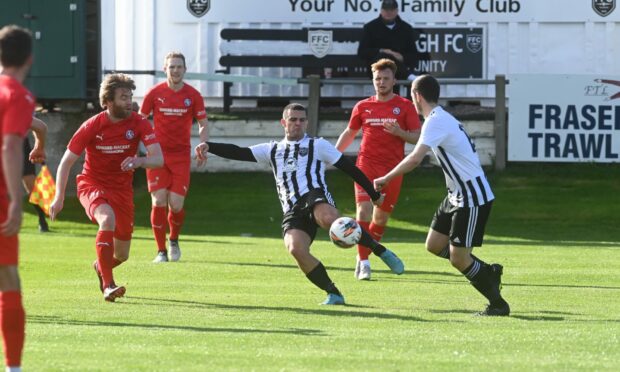 Scott Barbour, centre, has a shot for Fraserburgh against Brora Rangers