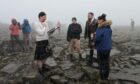 Natalie and Neil exhanging their vows with the humanist on Ben Nevis. Photo: Deadline