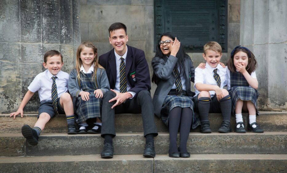 High School of Dundee students smile as they sit together