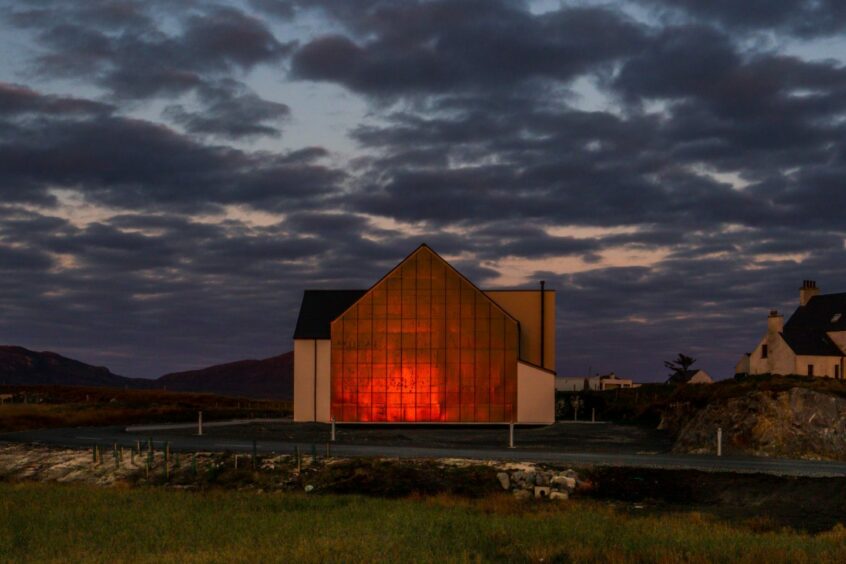 Sunset light on a building on a hill.