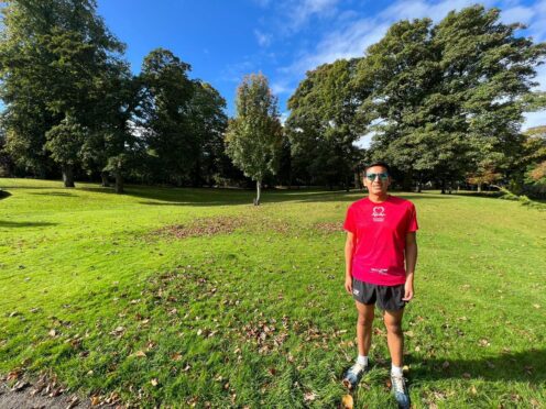 Dr Victor Velecela standing in running gear in the park getting ready for his maraton to raise money for heart disease research