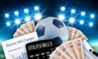 Football surrounded by £10 notes and utility bills