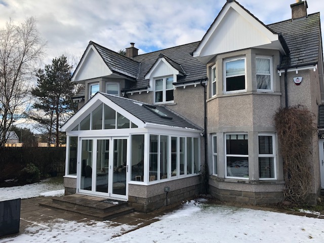 A picture of a conservatory in winter with a new roof - correlating the article about how to make a conservatory warmer