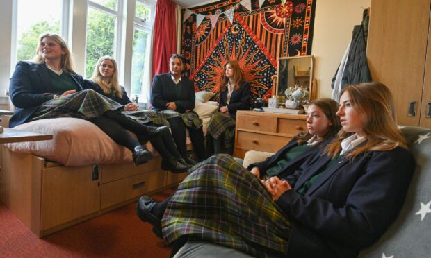 Gordonstoun students watching the Queen's funeral in King Charles's old bedroom. Picture by Jason Hedges.