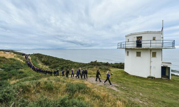 Seniors carrying out the commemorative walk to mark 70 years of the Queen's service. Picture by Jason Hedges.