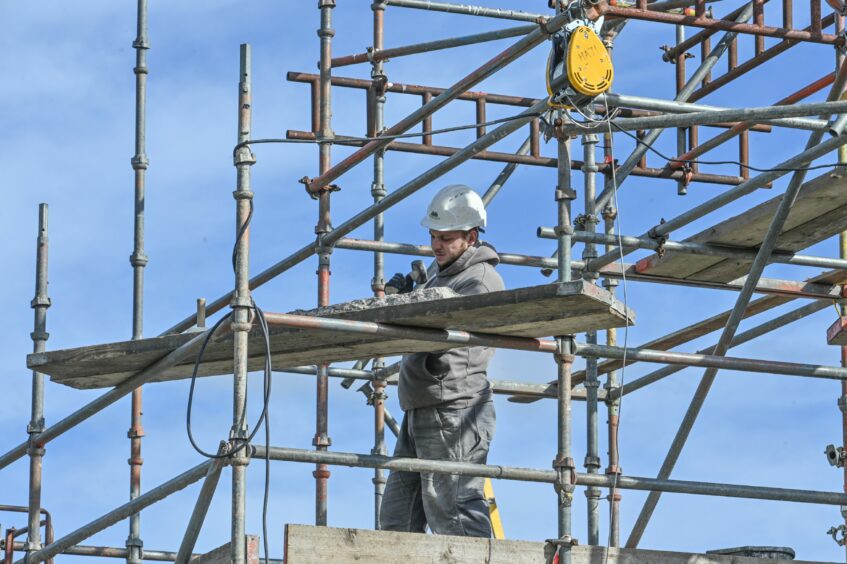 Workers at the site of the distillery and heritage centre. Picture by Jason Hedges