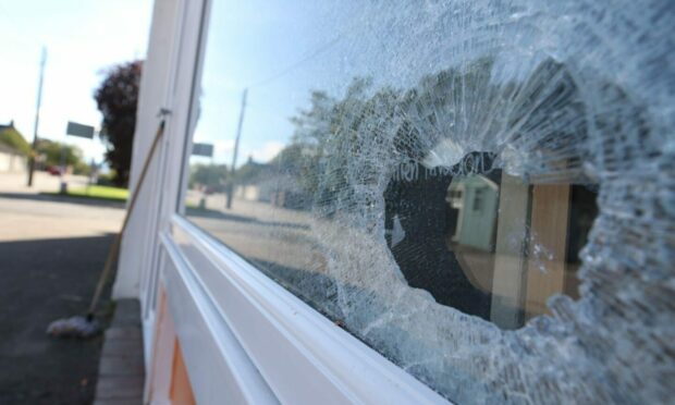 The window has been smashed at Jaki's Fish and Chip Shop. Photo: Andrew Smith.