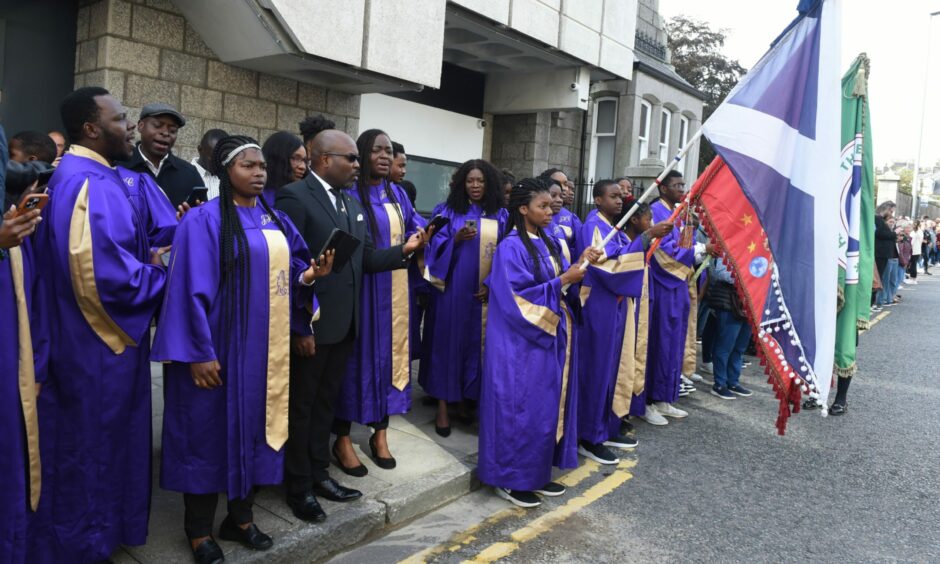 The congregation from the Redeemed Christian Church of God, Jesus House, Aberdeen gave a rousing performance of Amazing Grace as they waited for the Queen's cortege to pass. Picture by Kenny Elrick/DCT Media.