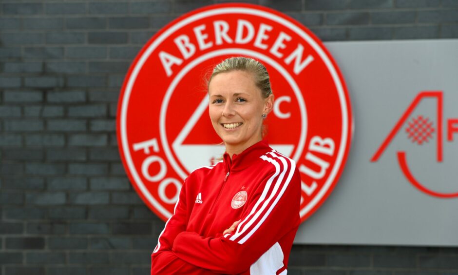 Loren Campbell in front of Aberdeen FC signage.
