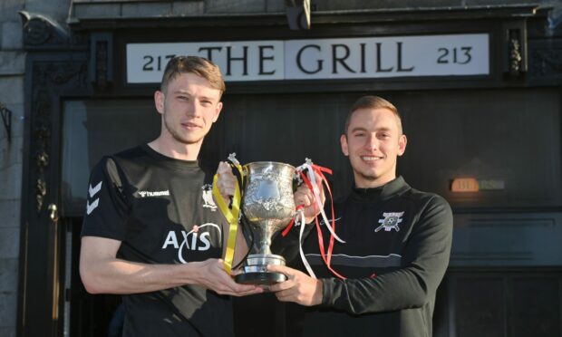 From left, East End captain Finlay Johnston and Culter captain Richie Petrie with the Grill League Cup. Image: Kenny Elrick / DC Thomson.