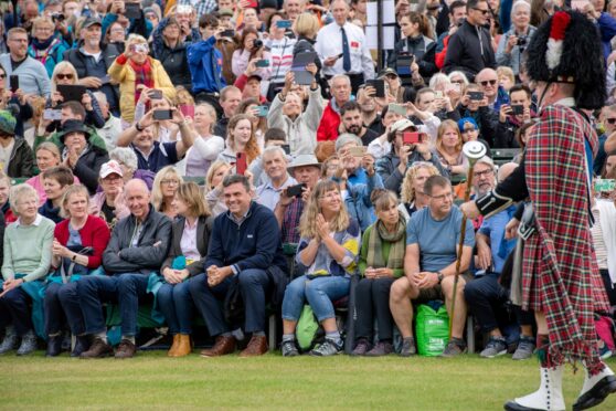 Crowds bring out their phones to record The Massed Pipe and Drums as they march around the arena at Braemar Gathering. Picture by KATH FLANNERY/DC Thomson